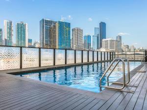 a swimming pool with a city skyline in the background at Peppers Docklands in Melbourne