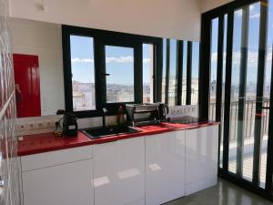 a kitchen with a counter top with a view of the city at Loft 360' Acropolis in Mesochórion