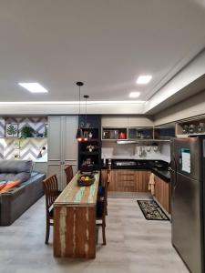 a large kitchen with a table and a couch at Unique Studio - Belíssimo Loft Mobiliado Cop30 in Belém