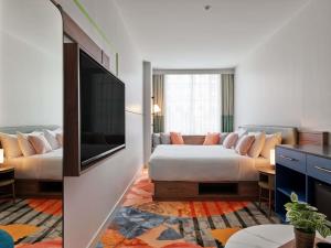a hotel room with a bed and a couch at The Clarence Hotel Sydney in Sydney