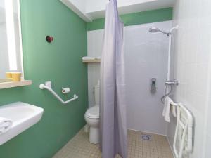a bathroom with a shower with a toilet and a sink at Greet Hôtel Dijon Sud Longvic in Longvic +27 photos