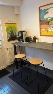 a counter with two stools and a counter top with a coffee maker at La Douce Angevine in Angers