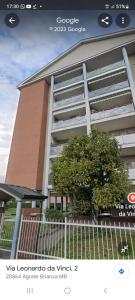 a picture of a building with a tree in front of it at Appartamento Vista Panoramica in Agrate Brianza