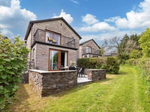 a brick house with a balcony and a yard at 2 Bed in St. Mellion 87701 in St Mellion
