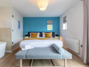 a bedroom with a large bed with a blue wall at 2 Bed in St. Mellion 87701 in St Mellion +51 photos