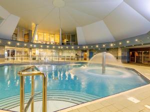 a large swimming pool with a fountain in a building at 2 Bed in St. Mellion 87701 in St Mellion