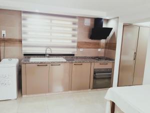a small kitchen with a sink and a refrigerator at Reposant in Bin Rhilouf