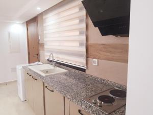 a kitchen with a sink and a counter top at Reposant in Bin Rhilouf