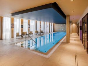 a large swimming pool in a hotel room at Movenpick Hotel Tallinn in Tallinn