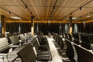 a row of chairs in a room with curtains at The West Inn-Georgia Hotel in Kutaisi +55 photos