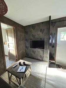 a living room with a table and a tv at Lillahuset in Sundsvall
