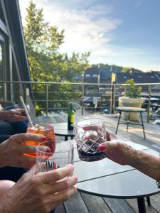 a group of people sitting at a table with drinks at Hotel La Caleche in Durbuy +24 photos