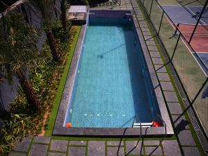 an overhead view of an empty swimming pool at HomeGround Sector 89 -1RK in Gurgaon