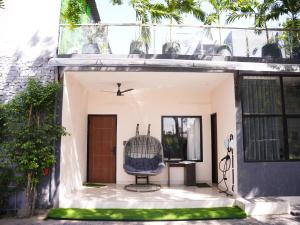 a chair sits on the porch of a house at HomeGround Sector 89 -1RK in Gurgaon