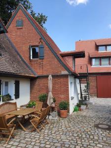 a patio with a table and umbrella and a building at Charming guest house in Nürnberg +3 photos