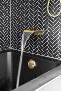 a water fountain in a bathroom with a black sink at Prime Location Top Rated Clean Parking Free! in Columbus +42 photos