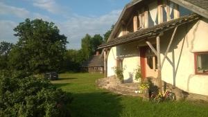 a house with a bike parked outside of it at Krāģīši - Quiet Countryside aura in Rencēni
