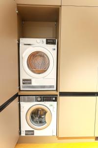 two washers and a washing machine in a closet at Apartmán MONTARA in Donovaly