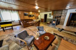 a living room filled with furniture and a piano at Chata Daniela in Dedinky