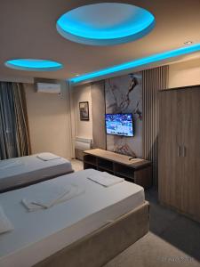a bedroom with two beds and a blue ceiling at Magic Apartments 2 in Ub +6 photos