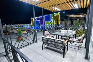 a patio with a table and chairs and a train at The West Inn-Georgia Hotel in Kutaisi