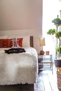 a bedroom with a white bed with a plate on it at Short North Convention Private Parking Pets! in Columbus +48 photos