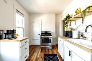 a kitchen with white cabinets and a sink at Short North Convention Private Parking Pets! in Columbus