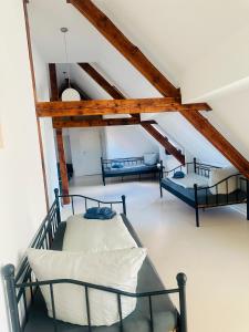 a room with three beds in a attic at Apartmenthouse Singen in Singen