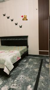 a bedroom with a bed with bats on the wall at Ahil house in Lahore