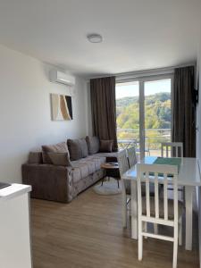 a living room with a couch and a table at Green panorama Vrdnik in Vrdnik
