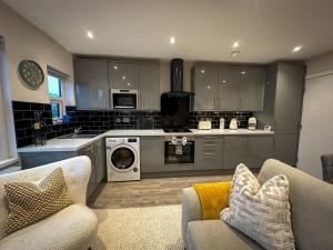 a kitchen with a washer and dryer in a room at Warm & Cosy, First Floor 2 Bed Central Apartment in Harrogate