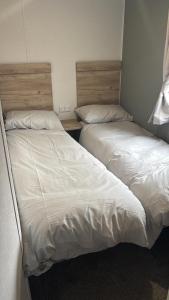 two beds sitting next to each other in a bedroom at A&l by the sea in Fleetwood