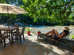 a woman sitting on a bench reading a book at Casa Terraza in El Zaino