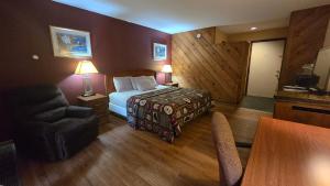 a hotel room with a bed and a table at Timber Inn Motel in Phillips