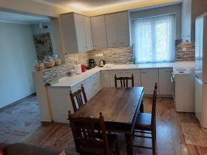 a kitchen with a wooden table and a table and chairs at Et In Arkadia Ego in Leonidion +23 photos
