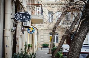 a sign on the side of a building at Nizami City Inn Hotel Baku in Baku