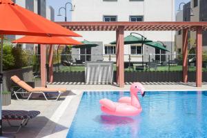 a pink swan float in a swimming pool at Mabaat-White Pearl Compound 600 B Villa 9 in Jeddah