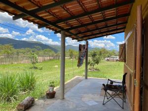 a patio with a chair and a view of a field at Cenário Cerrado in Cavalcante