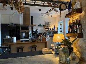 a kitchen with a counter and a table with a lamp at Mirada Do Roxo in Oia