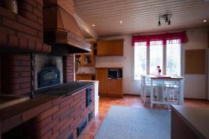 a kitchen with a brick oven and a counter top at Spacious detached house for a larger group in Rovaniemi +26 photos
