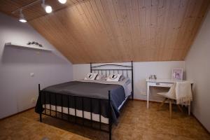 a bedroom with a bed and a wooden ceiling at Spacious detached house for a larger group in Rovaniemi