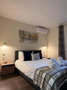 a bedroom with two beds and a painting on the wall at Apartment Zdravets 2, in the heart of the old city in Veliko Tŭrnovo