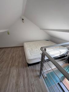 a room with a bunk bed in a attic at Charmant duplex aux portes de Belfort in Bavilliers