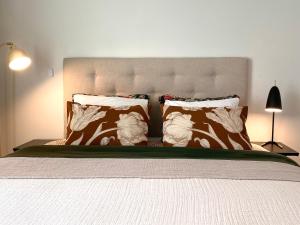 a bedroom with a large bed with two pillows at One More Night in Jyväskylä