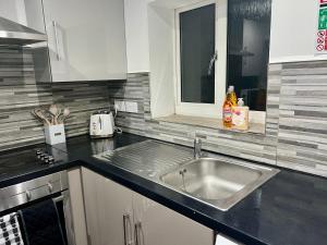 a kitchen with a sink and a counter top at New 3 Bed Preston City Centre No Parking- Sleeps 8 in Preston