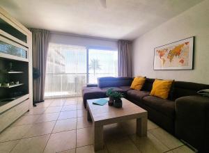 a living room with a couch and a table at Buena Vista Yaco See View Pool 2 Bedrooms in San Isidro