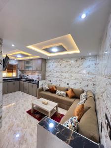 a living room with a couch and a kitchen at Tadinga Surf House in Imsouane