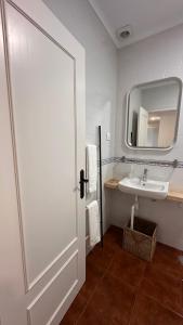 a bathroom with a sink and a mirror at Quinta de Carvalhal - Casa de Campo in Guimarães