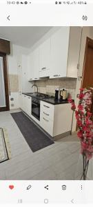 a kitchen with white cabinets and a stove top oven at La dimora di Gabi in Venice