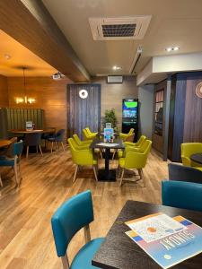 a waiting room with yellow chairs and a table at Driftwood dreams in Skipsea